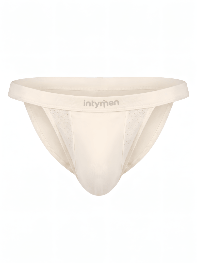 Tanga masculina beige Intymen con paneles y textura sobre fondo blanco.
