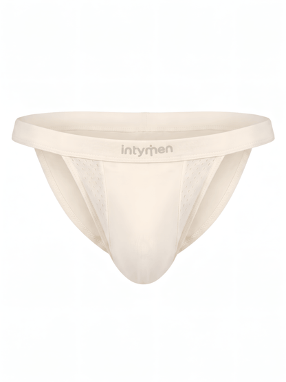 Tanga masculina beige Intymen con paneles y textura sobre fondo blanco.
